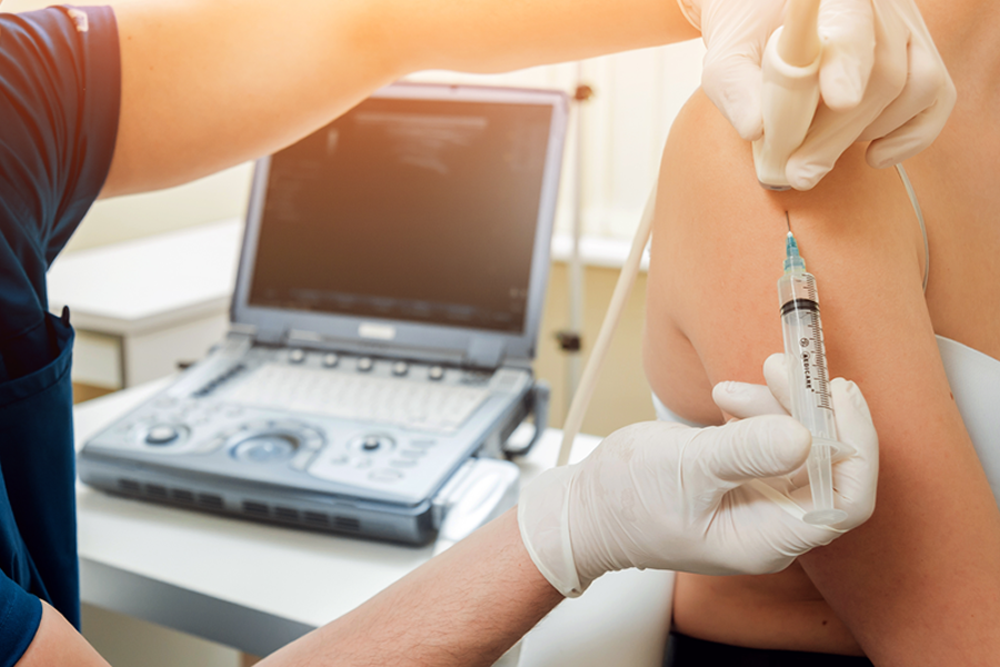 A medical professional administering a PRP injection for shoulder pain.